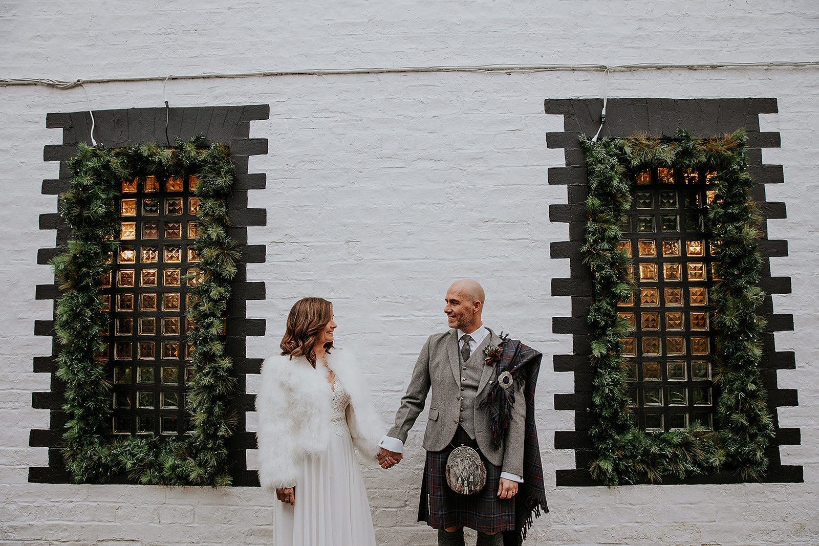 Newly married couple standing in between window set on Ashton Lane Glasgow