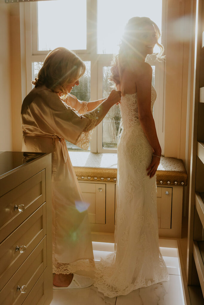 Bride getting ready at Brig o Doon with mum and sunlight