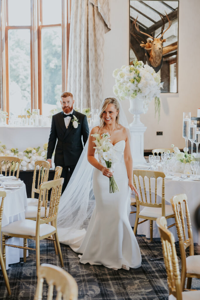 Newlyweds walking through dinner room of Brig o Doon