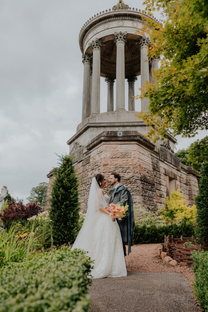 Newlyweds standing at Burns Monument 